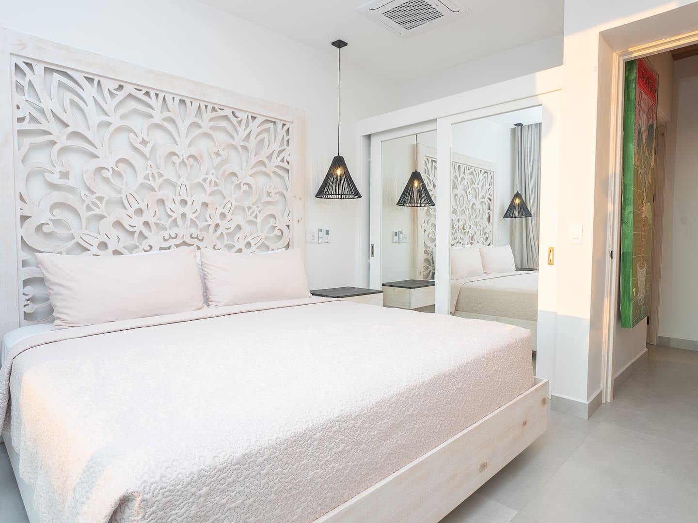 Fourth bedroom on the ground floor with a king bed and direct access to the pool